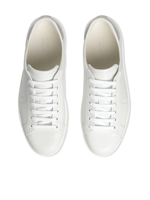 Sneakers with perforated logo