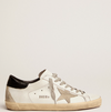 Super-Star with black heel tab and metal studs lettering "LAST PIECES"